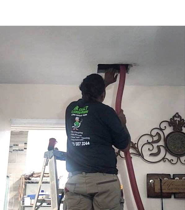 Technician using HEPA vacuum and Rotobrush to clean air ducts